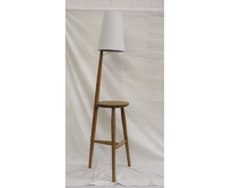 A modern light wood lamp and stand, the tripod stool form base with single angled support for the conical shade, 134cm high