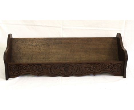 A large carved oak table book trough, carved with fruiting vines and florets, 74cm long