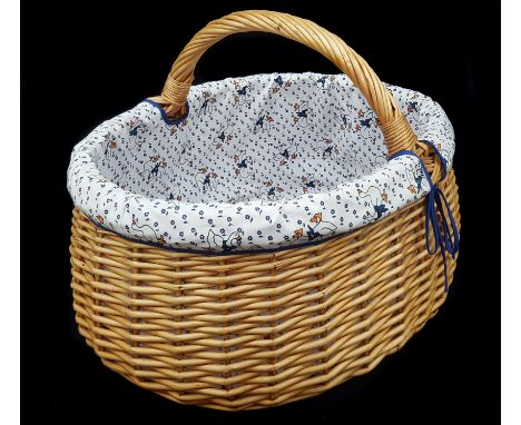 A vintage style wicker basket, lined with textiles, printed with ducks, 44cm max
