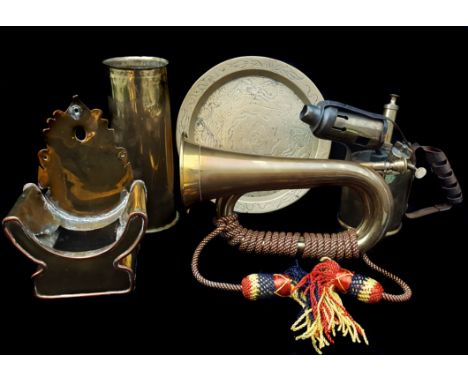 A WWI brass shell case marked 1915 and AEG; a bugle; a blow torch; a throne shaped offatory box; and an oriental brass tray (