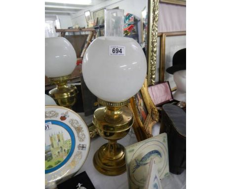 A brass oil lamp complete with shade and chimney. COLLECT ONLY.
