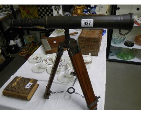 A brass adjustable telescope on tripod.