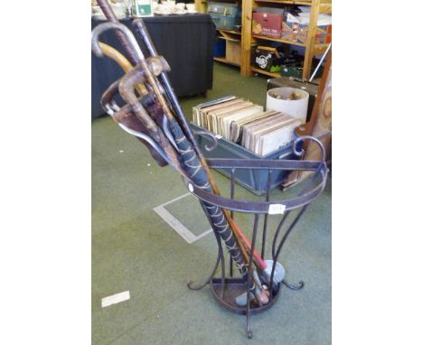 STEEL STICK STAND. Steel stick stand with sticks and silver handled umbrella