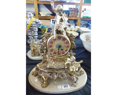 MANTEL CLOCK. Reproduction brass mantel clock with cherub decoration, H ~ 40cm