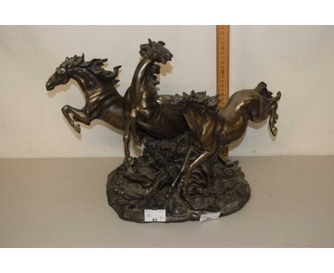 A modern Academy bronzed resin model of three horses 