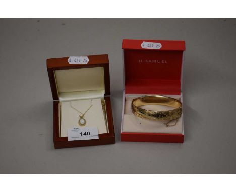 Rolled gold bangle together with a small opal pendant and chain