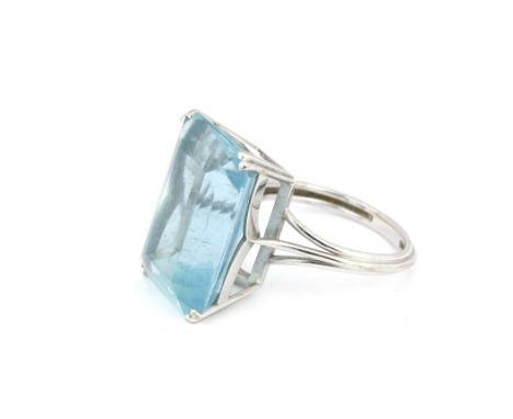 A white metal (tested minimum 9ct gold) ring set with a large cushion cut aquamarine, (S).
