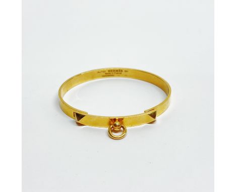 An 18ct gold Hermes bangle, W. 5.5cm. Approx 22g.