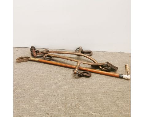 A pair of bronze horse hames with antler handle riding crop.