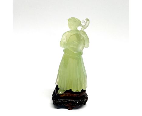 A lovely Chinese carved jade/hardstone figure of a musician on a carved wooden stand, H. 15cm.