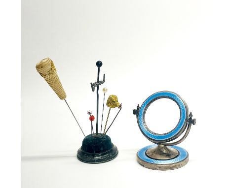 A hallmarked silver and enamel mirror/photograph frame, H. 9cm, together with a silver mounted hat pin stand and hat pins.