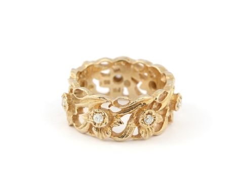 A 14ct yellow gold (marked 14K) Franklin Mint diamond set eternity ring by designer Stuart Devlin, (K). Approx. 6.7gr.