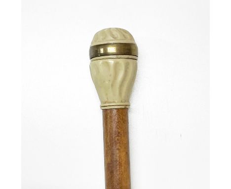 A compass topped walking cane.