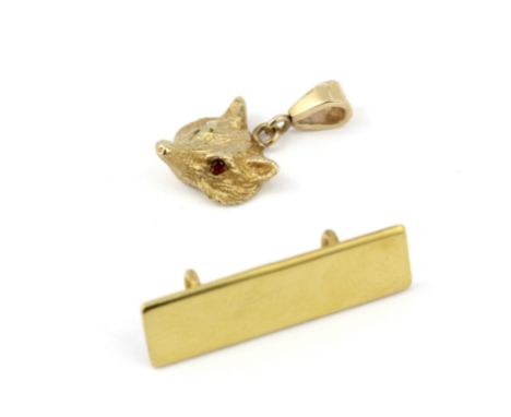 A hallmarked 9ct gold fox head pendant with ruby set eyes, L. 2cm, together with a further 9ct gold pendant.&nbsp;Approx. 4.5