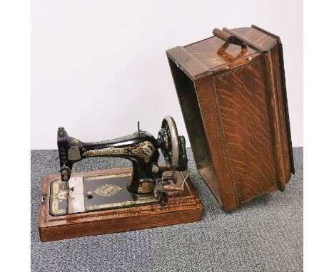 An oak cased Singer sewing machine.