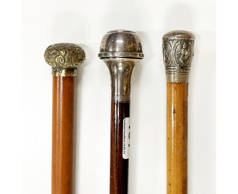 A hallmarked silver topped walking cane, together with two further canes.