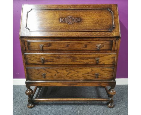 A three drawer oak bureau, 104 x 89 x 40cm.