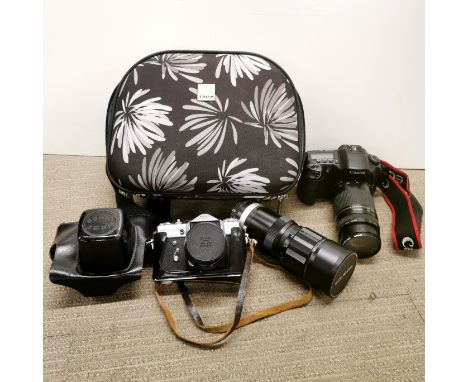 A Canon EOS10D single lens reflex camera with Canon zoom lens and Soligor auto zoom together with a Zenit camera.