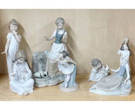 A group of Nao porcelain figurines with two Lladró and one other, tallest H. 30cm.