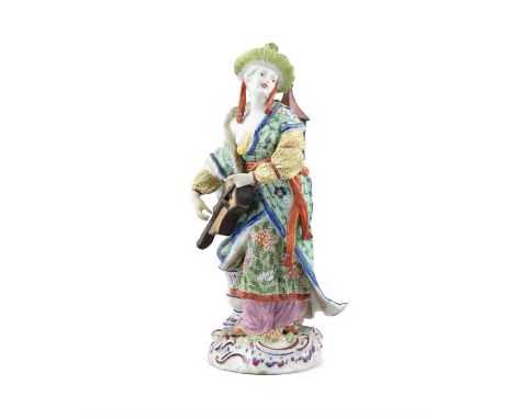 AN 18TH CENTURY CHINOISERIE  PORCELAIN FIGURE, European, modelled as a lady standing, holding a lute and carrying a lantern, 