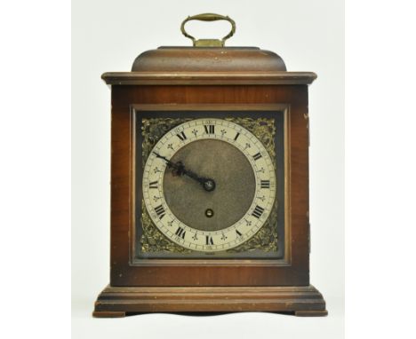 An early 20th century Tompion mantle clock. The clock with brass finial handle mounted atop square case, the face with Roman 