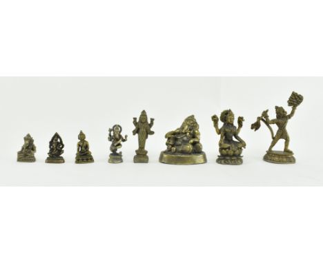 A collection of eight miniature Indian &amp; South-east Asian 20th century brass &amp; copper Hindu amulets. The amulets comp