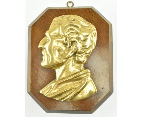 A 19th century Victorian brass wall portrait plaque depicting a classical Roman noble, possibly Seneca. The plaque mounted on