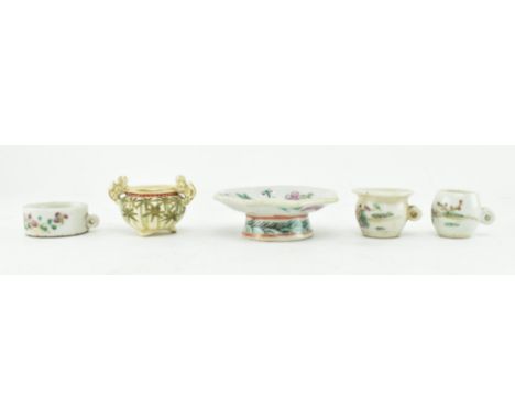 A collection of five pieces of an early 20th century ceramic doll's house tea service. The lot comprising two teacups and a b