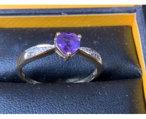 A 9ct gold ring with diamond and amethyst stones. Size O. 