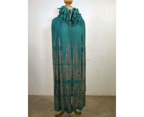 A light green chiffon Opera Cape circa 1920s, heavily embroidered and beaded with ruffled and padded collar. A rare item. Som