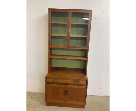 A G plan mid century two piece wall cupboard with glazed bookcase with two internal shelves above open shelf. Lower side boar