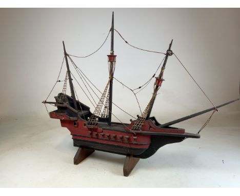 A model of a pirate ship on stand. 
