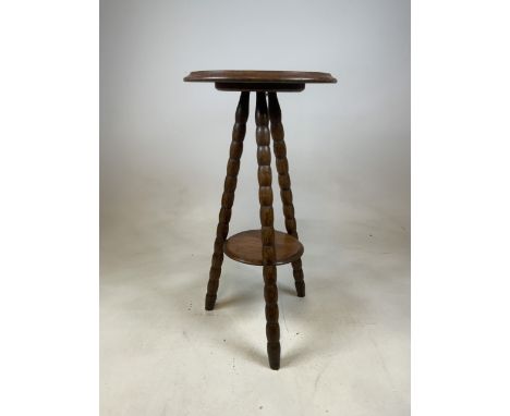 A bobbin turned three legged gypsie table with lower shelf. W:39cm x D:39cm x H:73cm