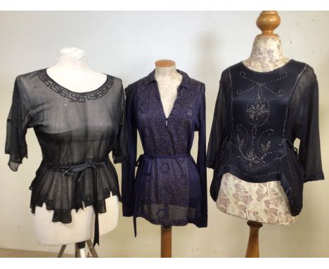 Three 1920s tops. A black semi sheer knitted top with embroidery detail at neck, sleeves and hem. A navy knitted long sleeved