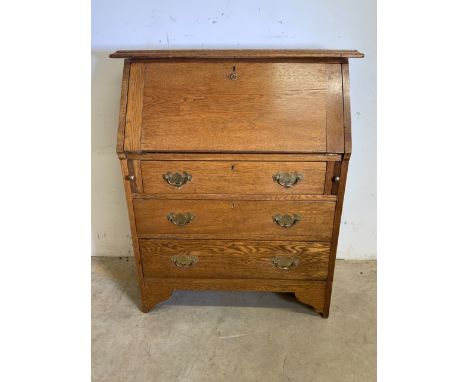 A 20th century light oak narrow bureau with pull out slides for drop down secretaire desk above three drawers. W:85cm x D:39c