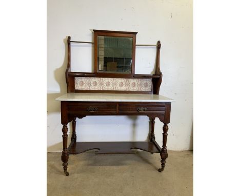 A victorian marble topped wash stand with tilled and mirror back with brass hanging rails, two drawers to base with turned le