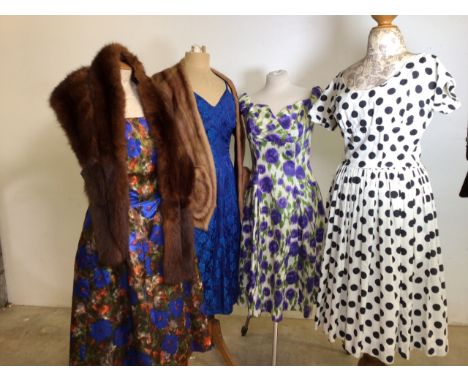 Mid century dresses together with two fur stoles. A cotton black and white spot dress by California, a a purple and green pri