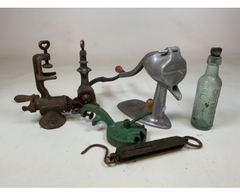 A collection of vintage mincers, scales and a glass bottle. 