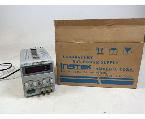 An Instek Laboratory D.C power supply machine with original box. Model number PS 3030D.  With instruction manual.