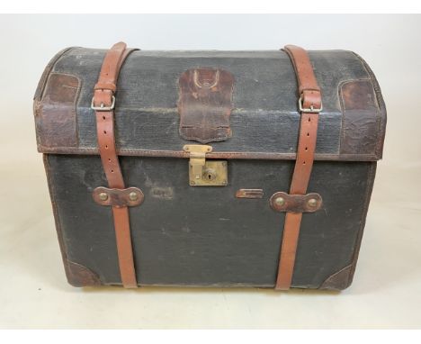 An Early 20th century domed top leather travelling trunk with wicker interior. W:78cm x D:52cm x H:63cm