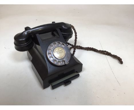A vintage Bakelite phone with pull out drawer in base. 