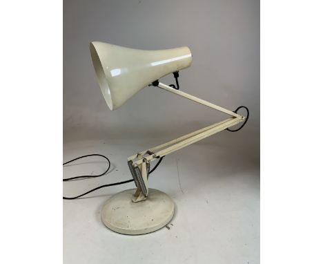 An cream angle poise lamp on circular base. 