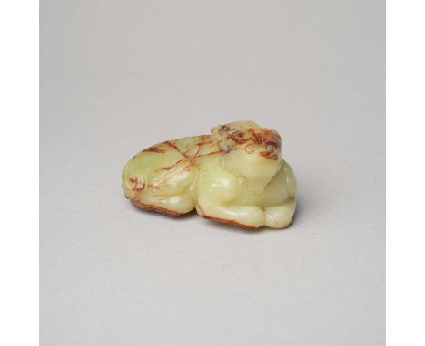 A CHINESE YELLOW AND RUSSET JADE CARVING OF A MYTHICAL BEASTQING DYNASTY9.8cm.The single-horned beast depicted in a recumbent