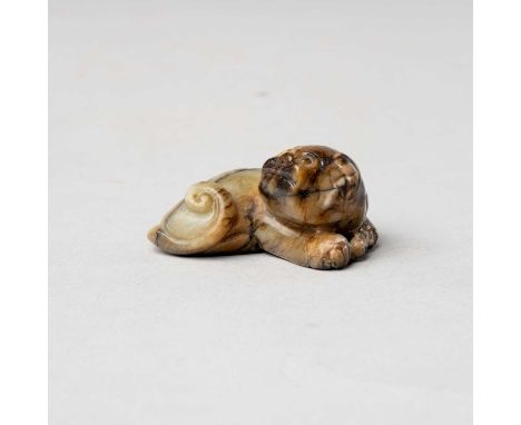 A CHINESE CELADON AND BROWN JADE CARVING OF A BUDDHIST LIONMING/QING DYNASTY5.8cm.The beast depicted lying down with its fron