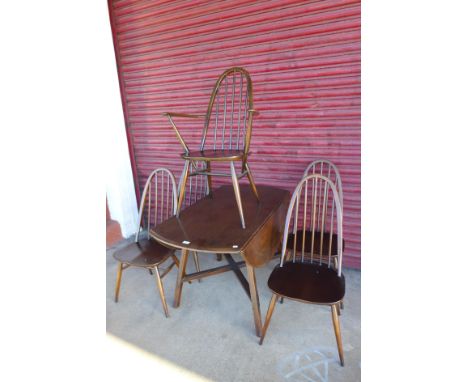 An Ercol dark elm and beech drop-leaf table and five chairs 