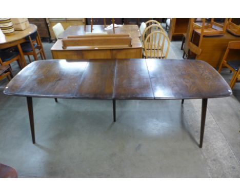 An Ercol dark elm and beech Grand Windsor extending dining table 