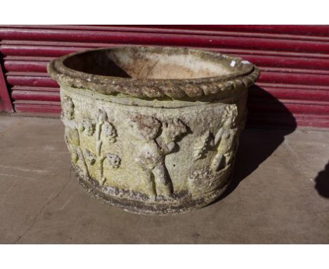 A moulded concrete cherub circular garden planter, 39cms h x 61cms d 