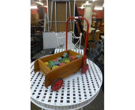 A vintage Tri-ang Baby Walker and building blocks 