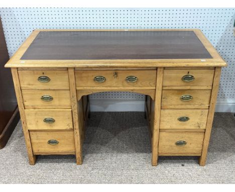 An Edwardian light oak Desk, with Rexine skived-in top, 48½in wide x 25½in deep x 40½in high (123cm x 65cm x 72cm) 