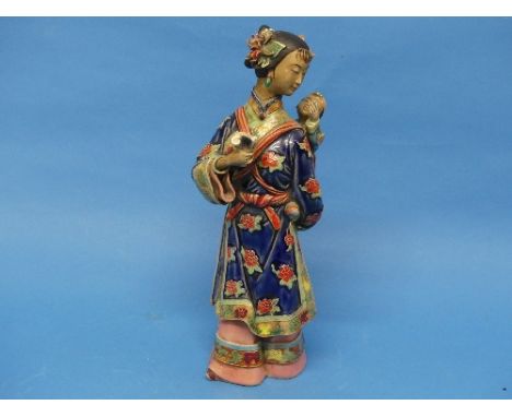 A 20thC Chinese ceramic Figure, of a lady carrying a child on her back, an impressed seal signature to underside also with a 